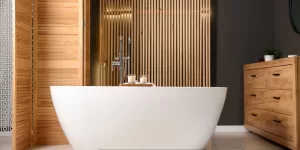 Modern bathroom with a freestanding white bathtub and wood-paneled wall design