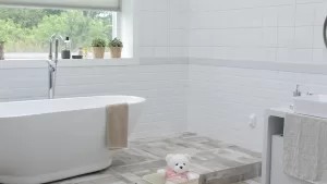 Bright bathroom with a freestanding soaking tub, large windows, and elegant finishes for bathroom remodeling in Ozark, MO.