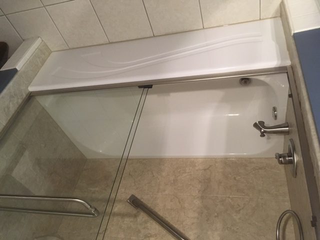Tub With Sliding Glass Shower Door And Tile Surround