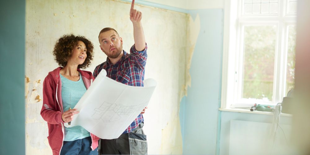 Couple reviewing plans for a bathroom remodel in Republic, MO
